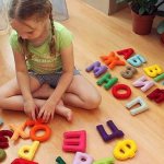 Girl with letter toys