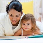 Mom and daughter looking at a book