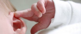 Newborn touching his ear